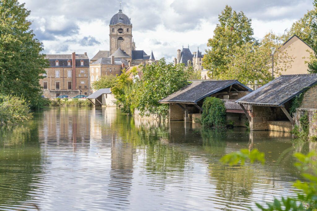 Alençon, France - 10 04 2020: Reflections of the Notre-Dame d'Alençon Basilica on the river