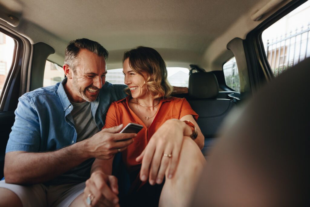 Beautiful couple in back seat of car