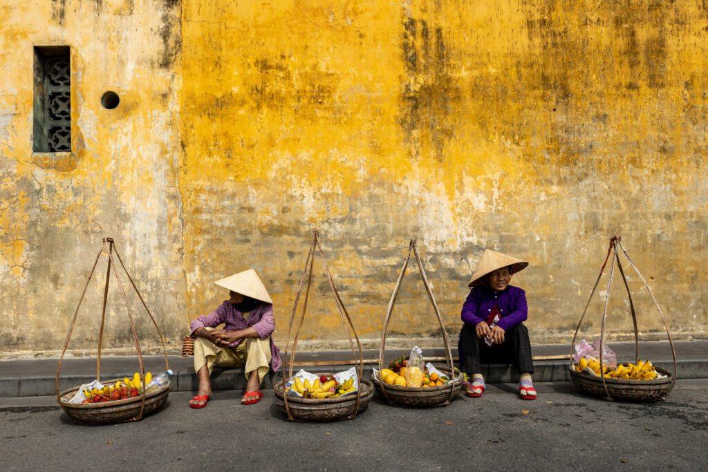 Old Woman from Vietnam is selling fruits in the Streets of Hoi An