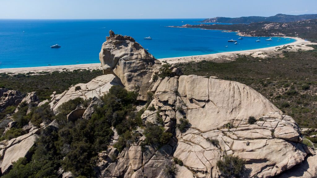 Aerial view of the famous "Lion of Roccapina", a rock formation at the top of a granite hill resembling a sleeping lion overlooking the Mediterranean Sea