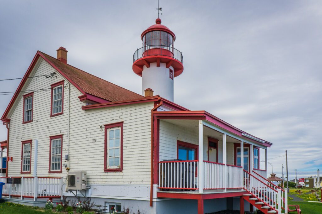 View on Matane's lighthouse, a red and white lighthouse located on the Northern shore of the Gaspesie peninsula, in the Bas Saint Laurent administrative region (Quebec, Canada)