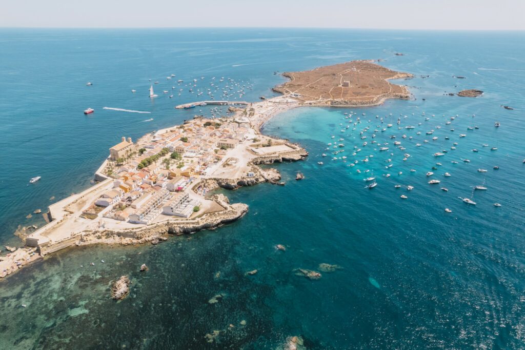 Aerial view of Tabarca island with boats at anchor. Mediterranean Sea. Popular travel destinations at summer. Spain.