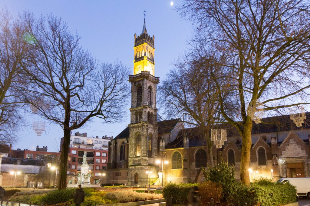 Valenciennes, France, 2017-01-05. The steeple with a bell and a clock of Saint Gery (Gaugericus) church at dusk.