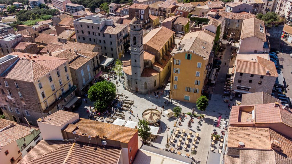 Aerial view of the Place de la République in the old city center of Porto-Vecchio in the South of Corsica, France - Church of Saint John the Baptist in a citadel built by the Genoese