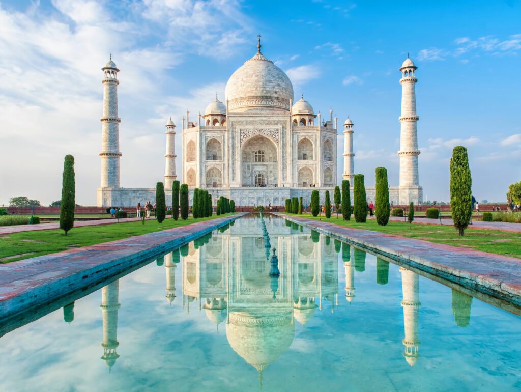 Amazing view on the Taj Mahal in sunset light with reflection in water. The Taj Mahal is an ivory-white marble mausoleum on the south bank of the Yamuna river. Agra, Uttar Pradesh, India.