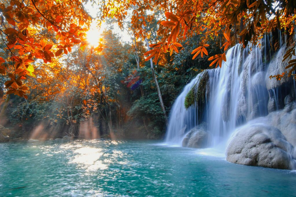 Scenic of nature Beautiful Waterfall with sunlight in autumn forest at Erawan  National Park, Thailand ,Travel amazing asia