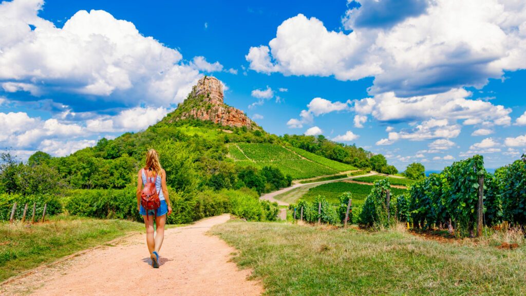 Woman tourist walking to Solutre Rock- Burgundy in France