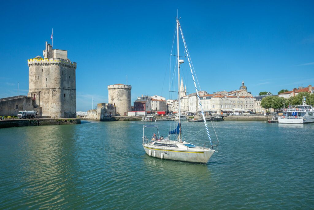 Sailboat entering harbour at La Rochelle, Charente-Maritime, France