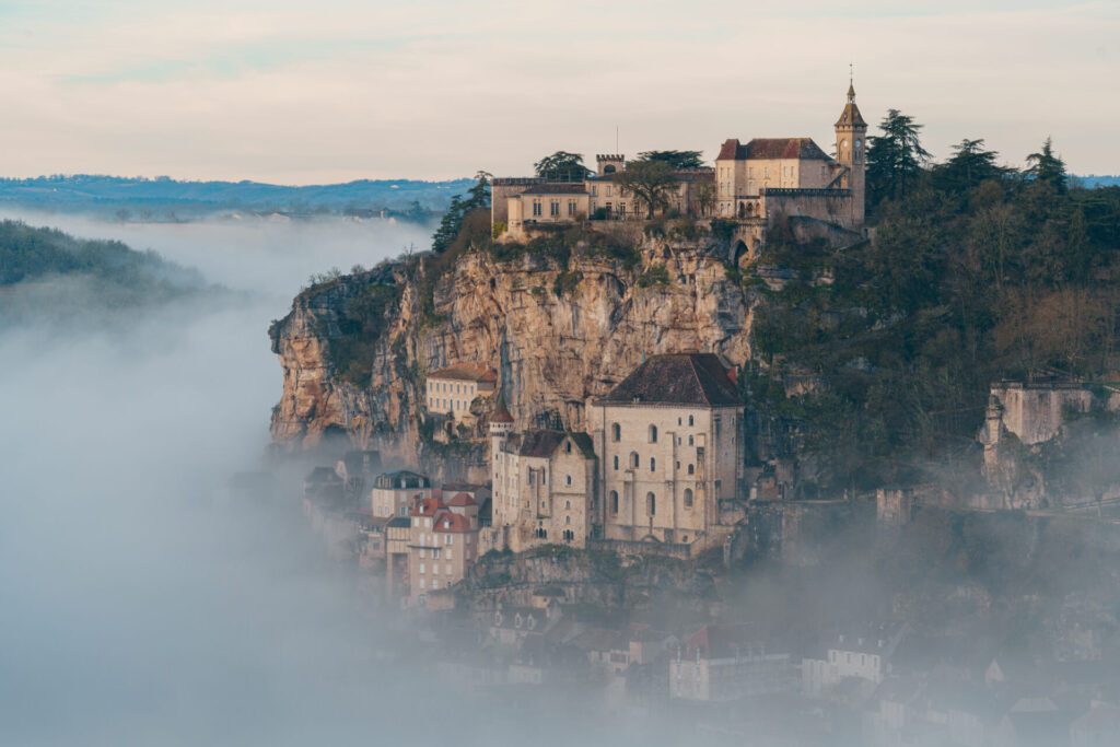 Rocamadour sunrise, Aerial view of the french village and castle on cliff in early morning with fogs in the Canyon of the Alzou