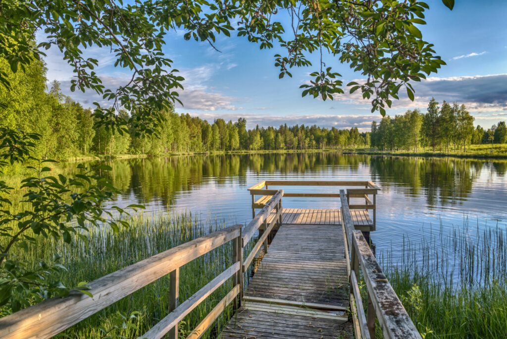 Pier with wooden benches at the lake in Lapland