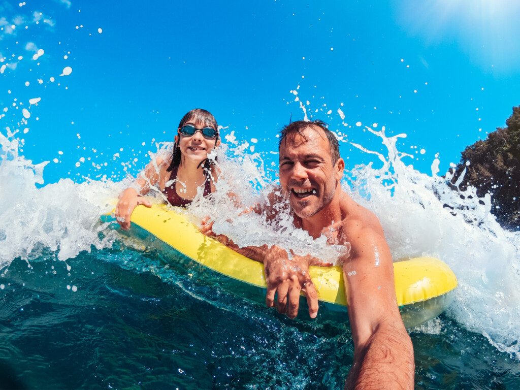 Moment de complicité entre père et fille s'amusent sur la plage